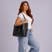 Mulher usando a bolsa shopper em couro  preto na versão aberta