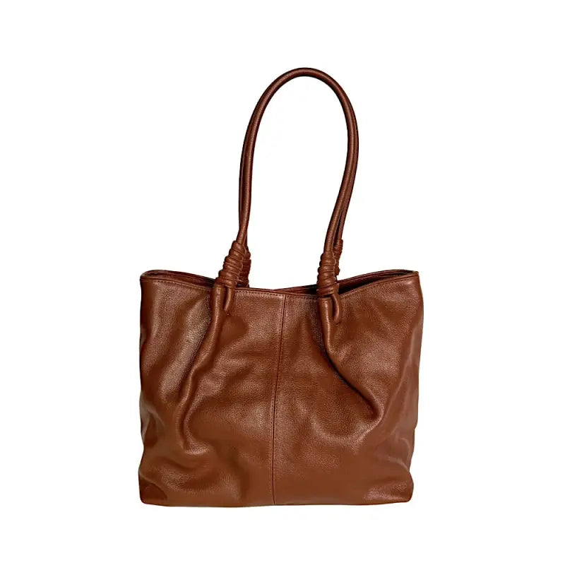 Bolsa tote bag feminina caramelo em couro legítimo floater com design de sacola estruturada e penses na base da alça.